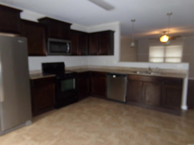 kitchen with stainless steel appliances, hanging light fixtures, and sink