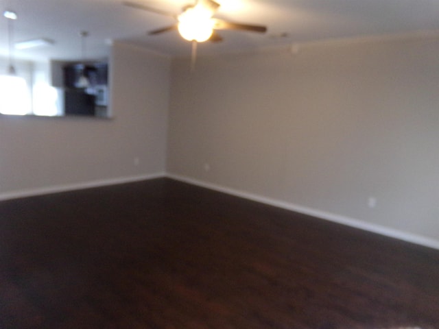 empty room with hardwood / wood-style floors and ceiling fan