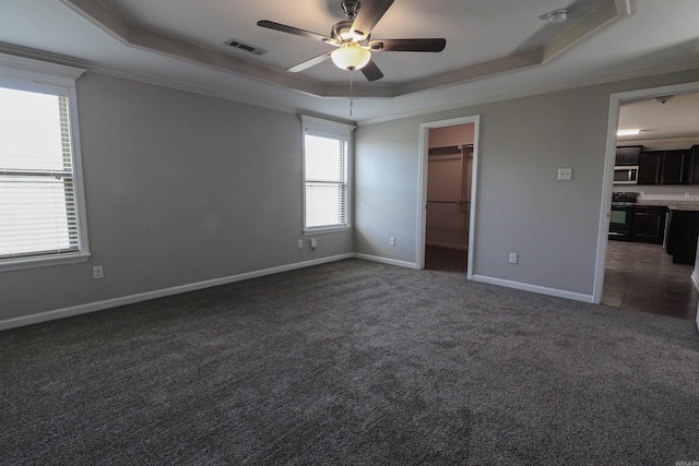 14465 Skyline Dr, Alexander, AR 72002 - unfurnished bedroom featuring a raised ceiling, dark carpet, a walk in closet, baseboards, and ornamental molding