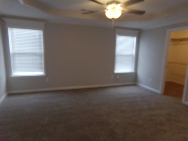 unfurnished room featuring ceiling fan and carpet