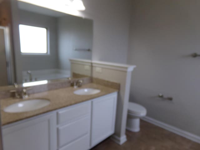 bathroom featuring vanity and toilet