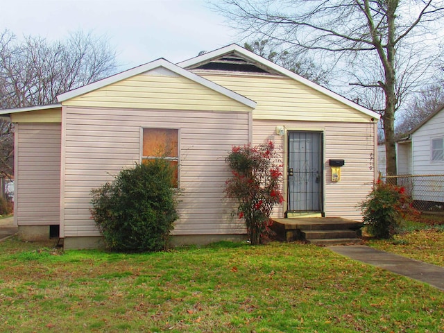 bungalow-style home featuring a front yard