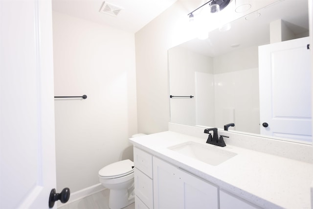 bathroom with vanity and toilet