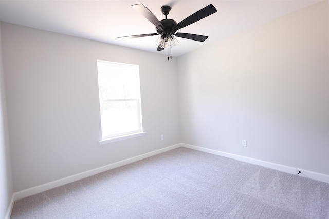 spare room featuring ceiling fan and carpet floors