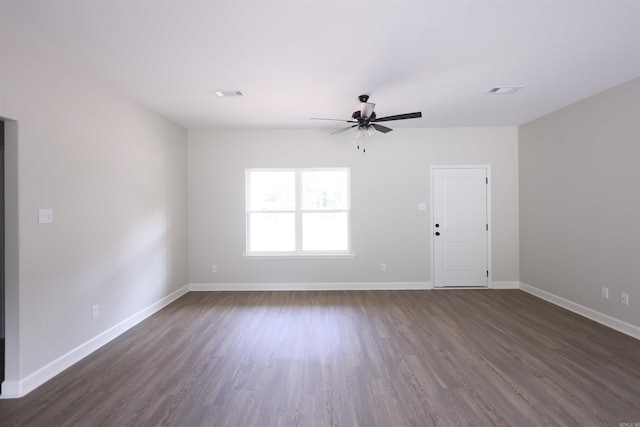 empty room with dark hardwood / wood-style floors and ceiling fan