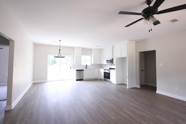 unfurnished living room with ceiling fan, sink, and dark hardwood / wood-style flooring