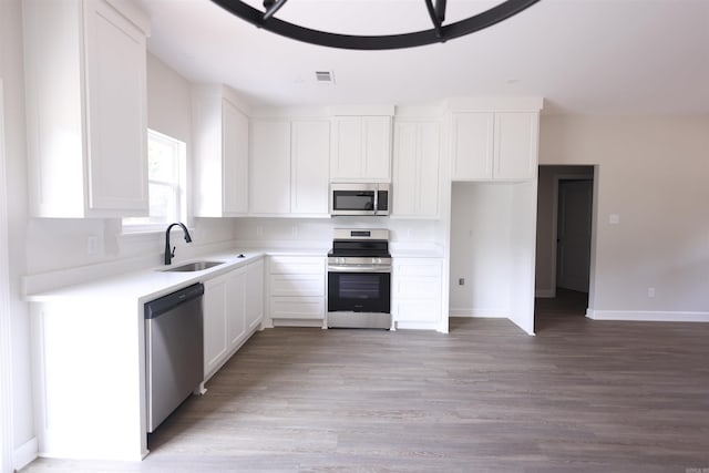 kitchen featuring sink, light wood-type flooring, white cabinets, and appliances with stainless steel finishes