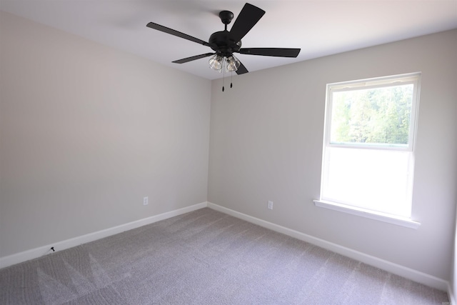 empty room with ceiling fan and carpet flooring