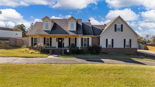 cape cod home with a porch and a front yard