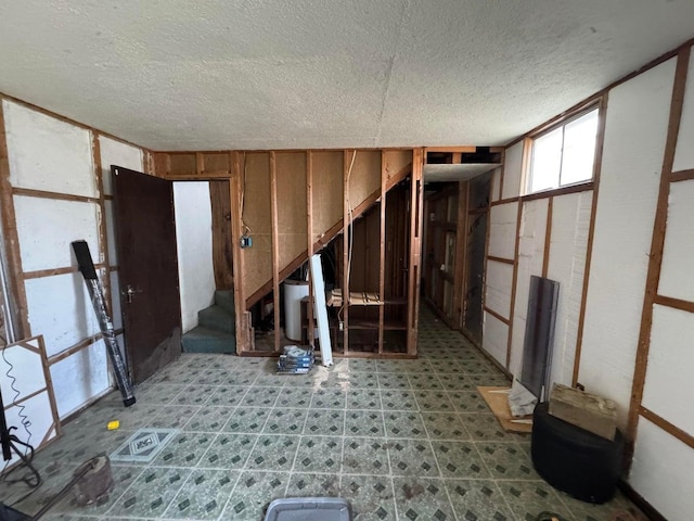 basement featuring a textured ceiling