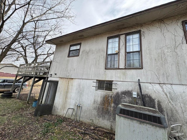 view of side of home featuring central AC and a deck