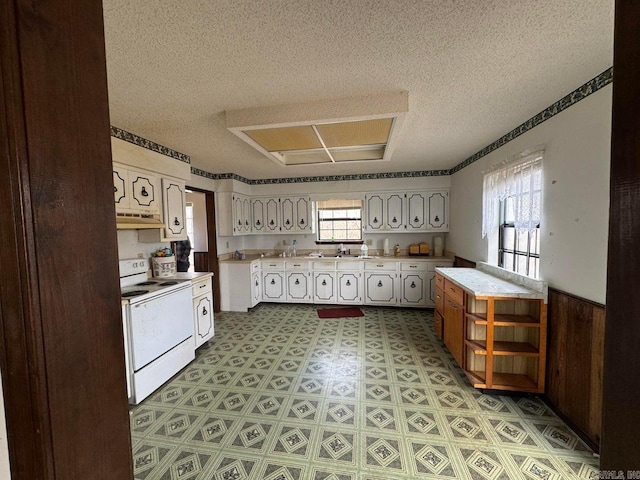 kitchen featuring electric range and a textured ceiling