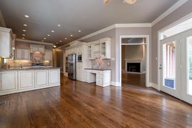 kitchen featuring sink, dark hardwood / wood-style floors, custom range hood, and appliances with stainless steel finishes