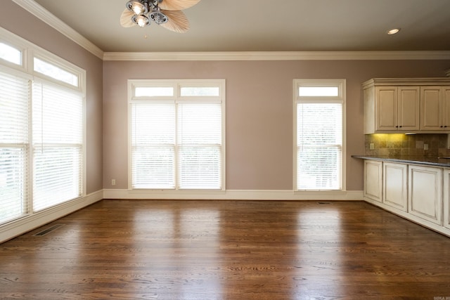 unfurnished dining area with ornamental molding, dark hardwood / wood-style floors, and ceiling fan