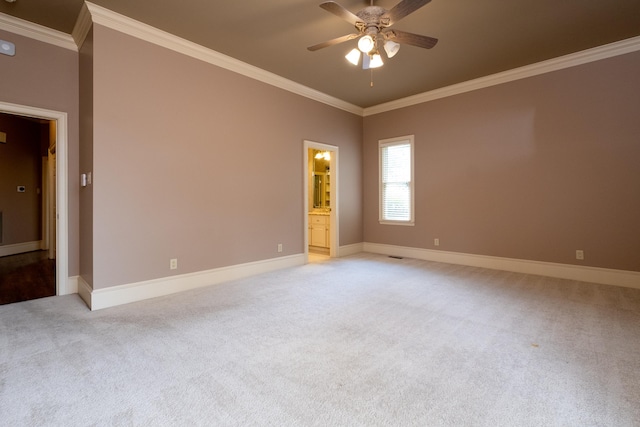 empty room with crown molding, light colored carpet, and ceiling fan