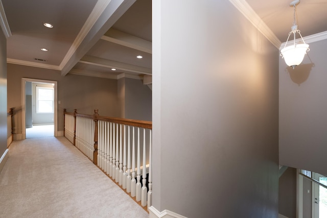 hallway with ornamental molding, beam ceiling, and light carpet