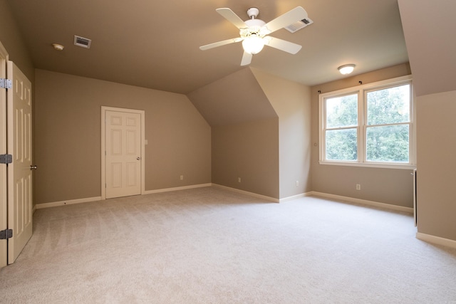 bonus room featuring ceiling fan, lofted ceiling, and light carpet