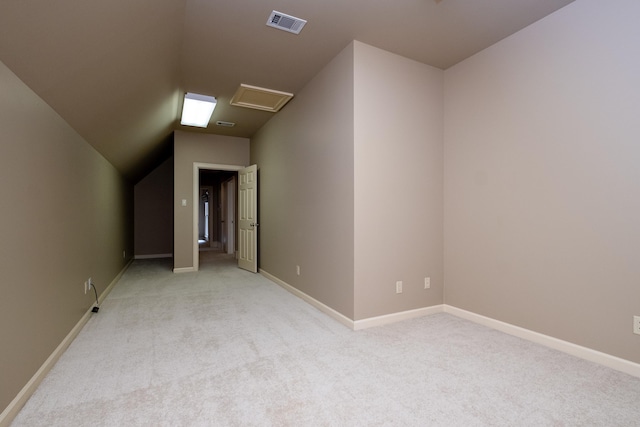 unfurnished room featuring vaulted ceiling and light carpet