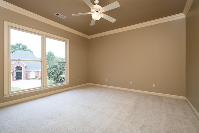 carpeted spare room featuring ceiling fan and ornamental molding