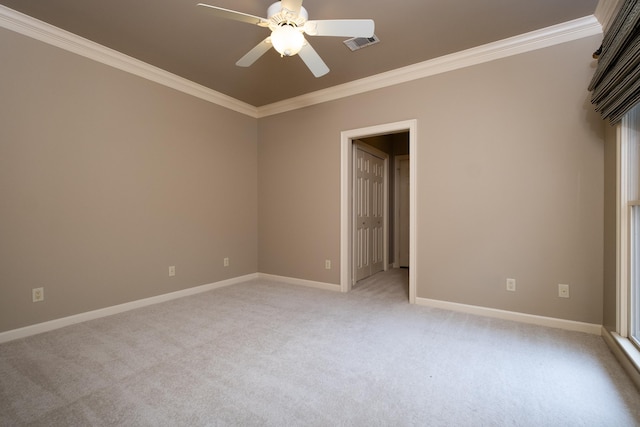 carpeted spare room with ornamental molding and ceiling fan