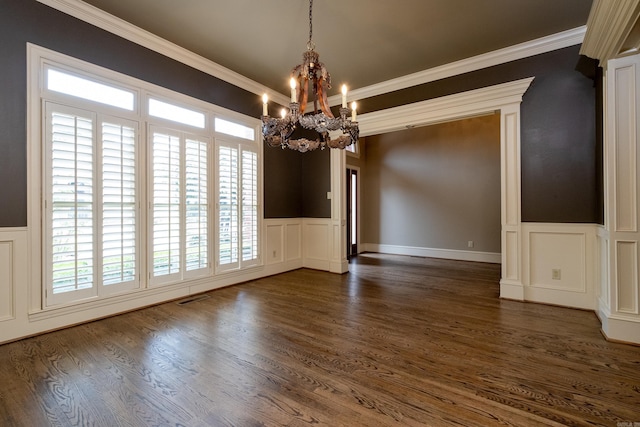 unfurnished dining area with crown molding, dark hardwood / wood-style flooring, and a notable chandelier