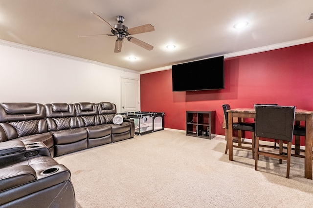 carpeted cinema featuring crown molding and ceiling fan