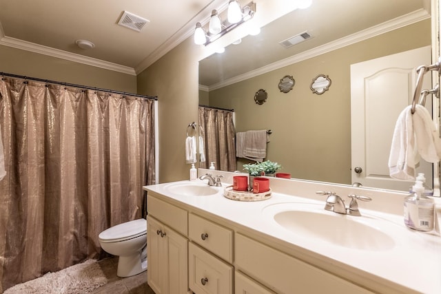 bathroom with vanity, crown molding, and toilet