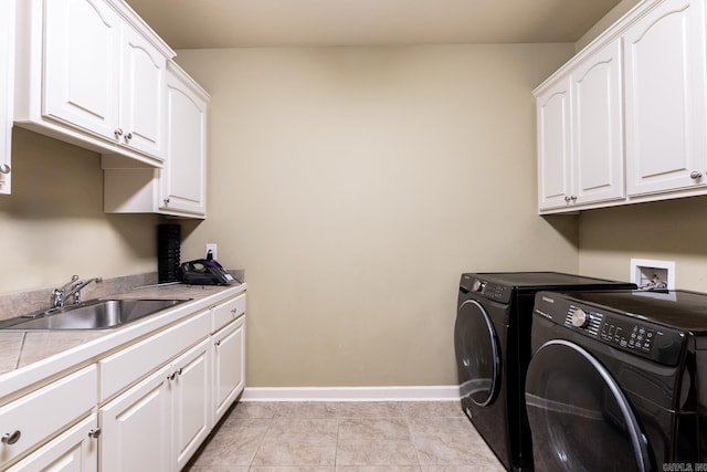 clothes washing area with cabinets, separate washer and dryer, sink, and light tile patterned floors