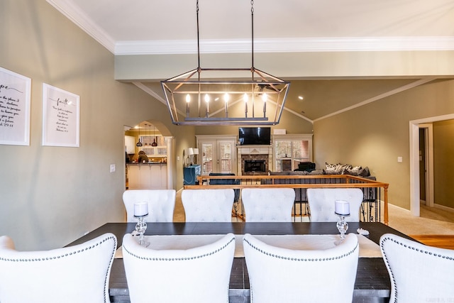 dining space with vaulted ceiling, ornamental molding, carpet, and an inviting chandelier