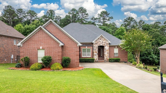 28 Bronte Ct, Little Rock, AR 72223 - traditional-style home with brick siding, a front lawn, concrete driveway, and roof with shingles