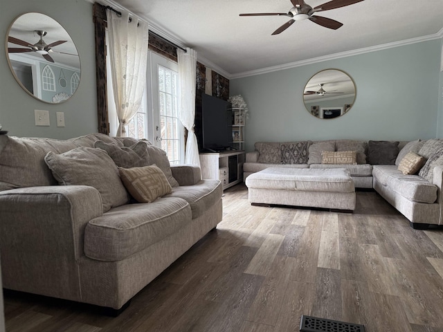 living room with hardwood / wood-style flooring, ceiling fan, and ornamental molding