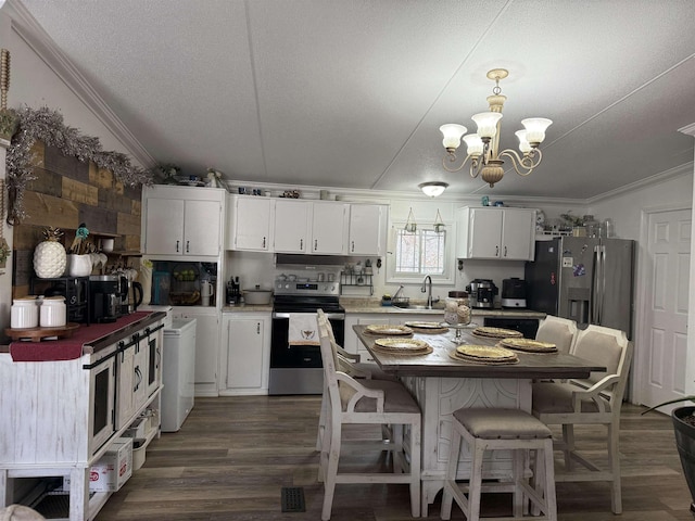 kitchen with white cabinetry, hanging light fixtures, ornamental molding, dark hardwood / wood-style flooring, and stainless steel appliances