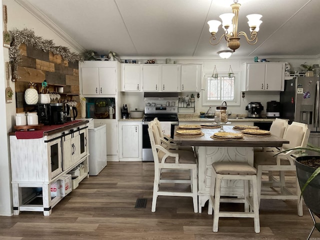 kitchen featuring crown molding, appliances with stainless steel finishes, hanging light fixtures, and white cabinets