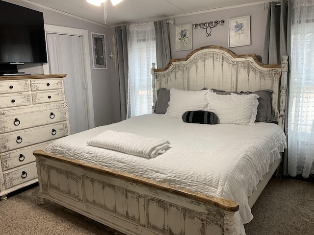 carpeted bedroom featuring multiple windows and vaulted ceiling