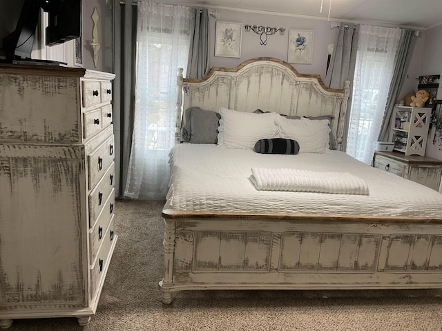 bedroom featuring ornamental molding and carpet flooring