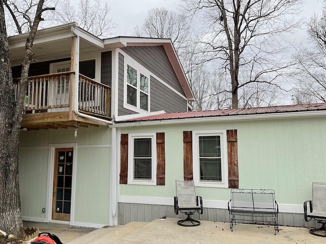 back of house featuring a patio area and a balcony