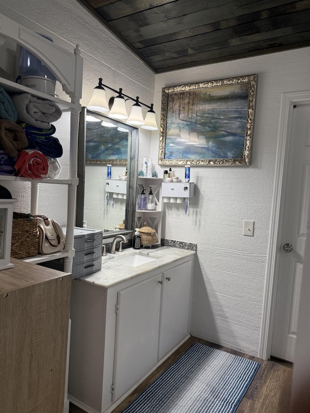 interior space featuring vanity, hardwood / wood-style floors, and wood ceiling