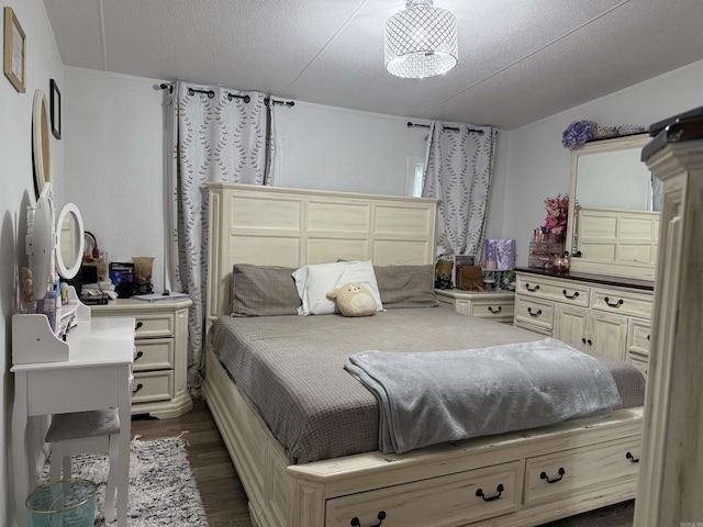 bedroom with dark hardwood / wood-style flooring and a textured ceiling