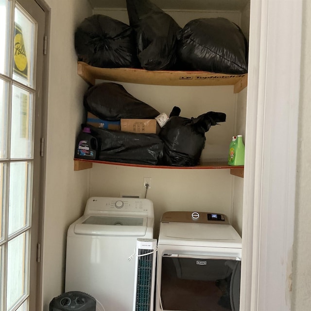 laundry room with plenty of natural light and washing machine and clothes dryer