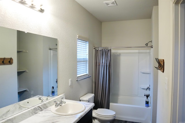 full bathroom with vanity, shower / bathtub combination with curtain, and toilet