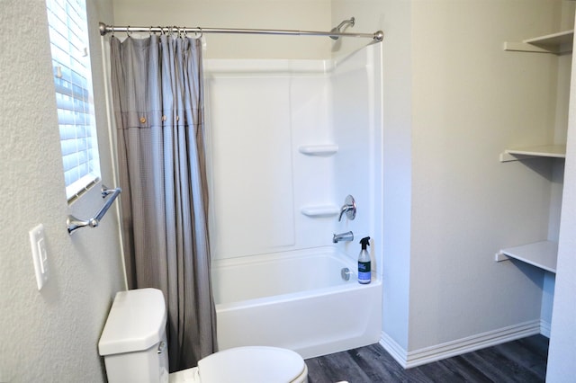 bathroom featuring hardwood / wood-style flooring, shower / bathtub combination with curtain, and toilet