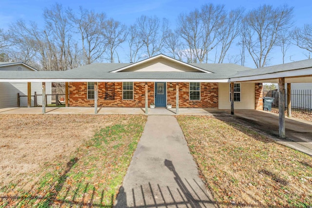 single story home featuring a carport and a front yard