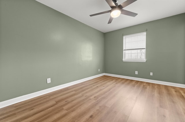 empty room with ceiling fan and light hardwood / wood-style floors