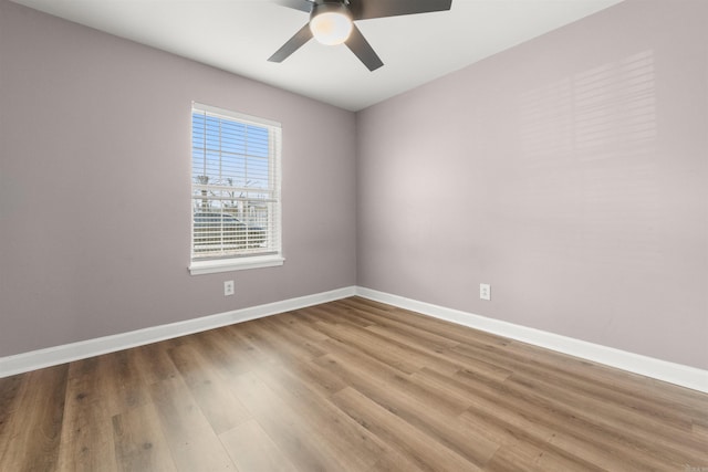 unfurnished room with hardwood / wood-style floors and ceiling fan