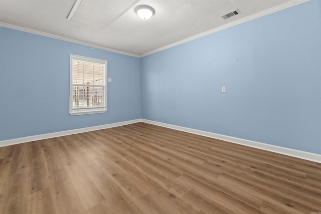 unfurnished room with ornamental molding and wood-type flooring