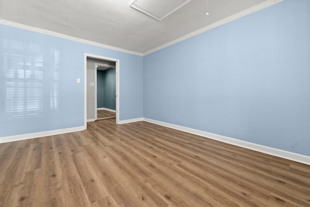 spare room with crown molding and hardwood / wood-style flooring