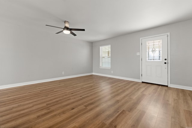 foyer entrance with hardwood / wood-style floors and ceiling fan