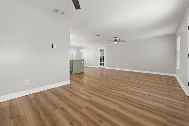 unfurnished living room featuring wood-type flooring and ceiling fan