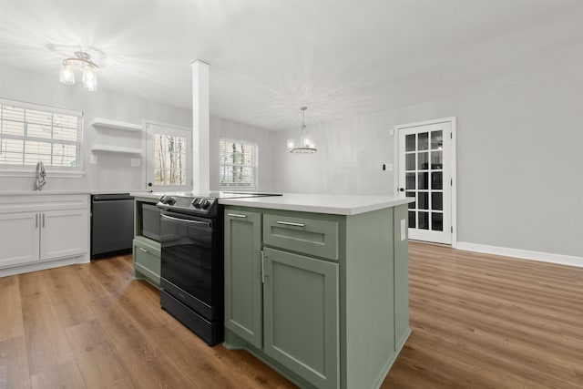 kitchen featuring sink, green cabinets, hanging light fixtures, black appliances, and a kitchen island