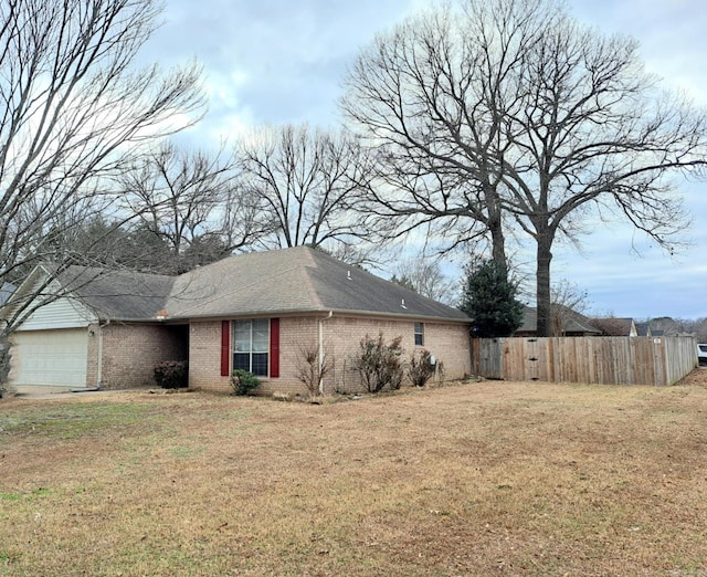 view of home's exterior with a garage and a lawn